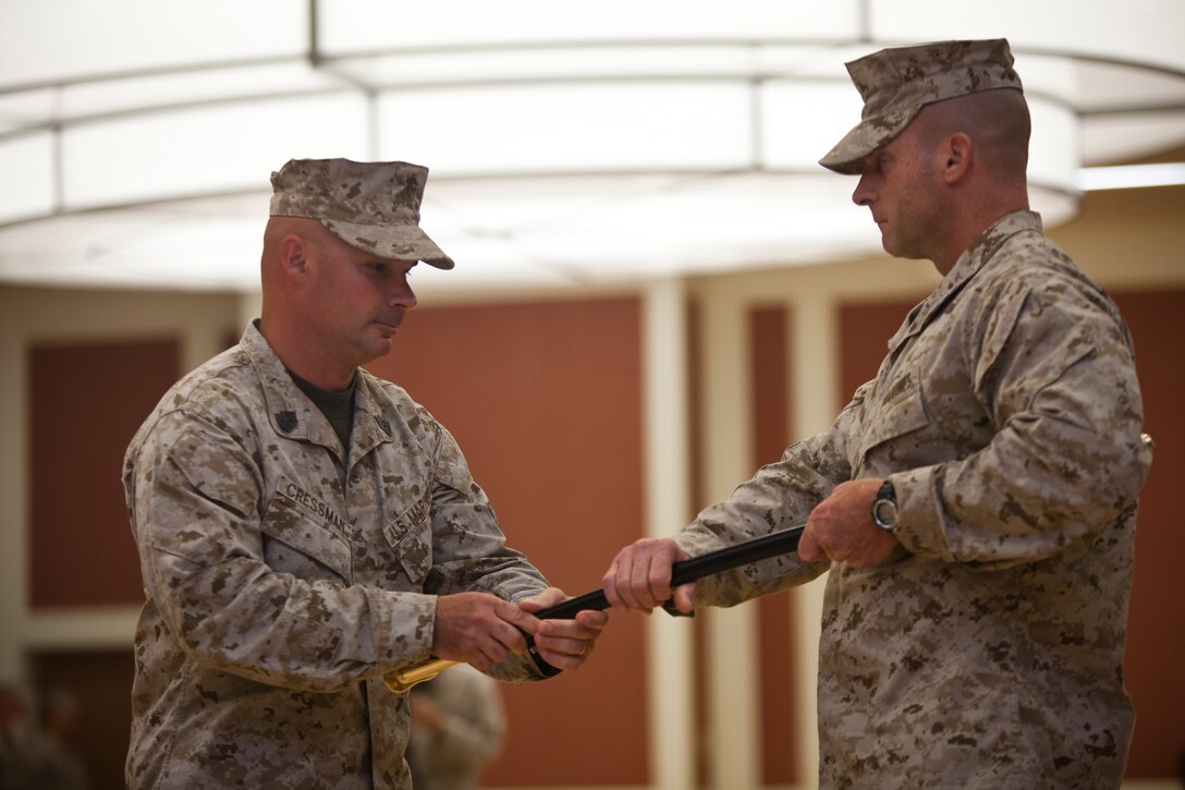 Sergeant Maj. Craig D. Cressman, the outgoing sergeant major of II Marine Expeditionary Force Headquarters Group, relinquishes the sword of office to Col. James B. Stopa, commanding officer of II MHG, during a relief and appointment ceremony at Camp Lejeune, Aug. 2. Cressman has spent nearly two years as the command's senior enlisted advisor during which they deployed to Helmand Province, Afghanistan as Task Force Belleau Wood in support of Operation Enduring Freedom. He will be taking over the duties as the sergeant major of Headquarters and Service Battalion, Headquarters Marine Corps, Henderson Hall located in Washington D.C.