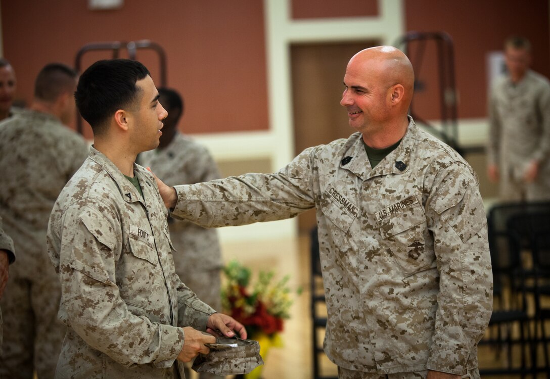 Sergeant Maj. Craig D. Cressman, the outgoing sergeant major of II Marine Expeditionary Force Headquarters Group, chats Lance Cpl. Christopher Fouts, a data network specialist with II MHG, following a relief and appointment ceremony at Camp Lejeune, Aug. 2. Cressman has spent nearly two years as the command's senior enlisted advisor during which they deployed to Helmand Province, Afghanistan as Task Force Belleau Wood in support of Operation Enduring Freedom. He will be taking over the duties as the sergeant major of Headquarters and Service Battalion, Headquarters Marine Corps, Henderson Hall located in Washington D.C.