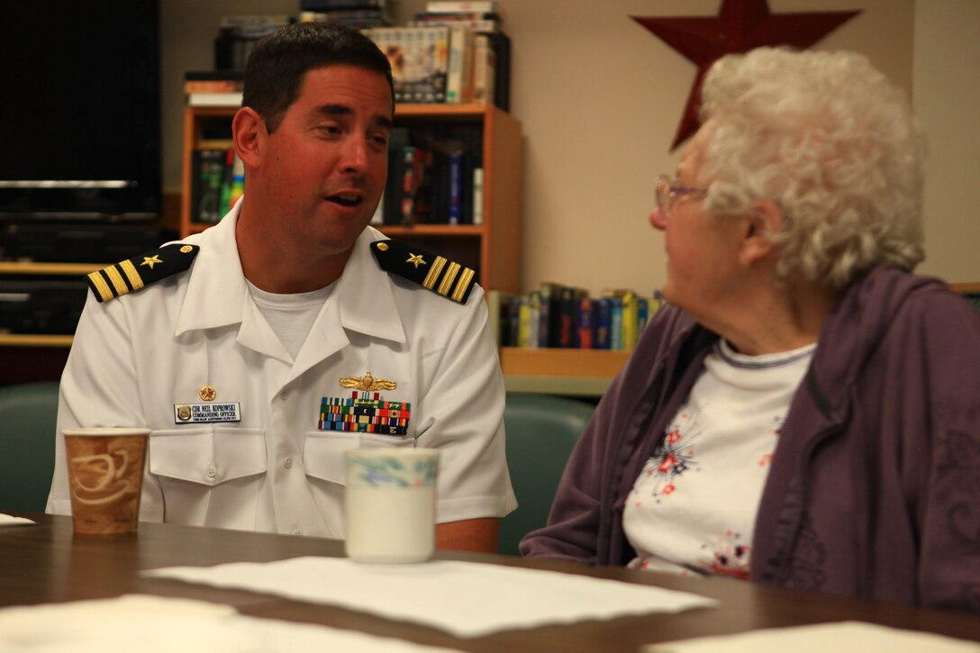 Cmdr. Neil Koprowski, commanding officer of the USS San Antonio, speaks with a resident of the Knox Center, a nursing facility in Rockland, Maine, during the 2012 Lobster Festival, Aug. 2, 2012. Koprowski’s crew joined Marines and sailors from Combat Logistics Regiment 27, 2nd Marine Logistics Group to take part in the festival from Aug. 1 to 5 and interact with the people of Maine. (Photo by Lance Cpl. Paul Peterson)