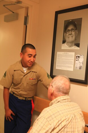 Cpl. Jaime Rodriguez, a radio operator with Combat Logistics Regiment 27, 2nd Marine Logistics Group, speaks with Herald Achorn, who served as a Seabee in World War II and is currently a resident of Knox Center in Rockland, Maine, Aug. 2, 2012. A picture commemorating Achorn’s service hangs in the center. More than 25 Marines and sailors from CLR-27 and the USS San Antonio visited the long-term care nursing facility. (Photo by Lance Cpl. Paul Peterson)