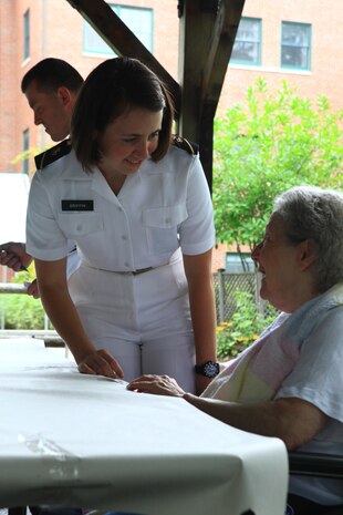 Midshipman 3rd Class Cynthia Griffin of the USS San Antonio speaks with a resident of Knox Center, a long-term care nursing facility in Rockland, Maine, during a community relations visit Aug. 2, 2012. More than 25 Marines and sailors from Combat Logistics Regiment 27, 2nd Marine Logistics Group and the San Antonio’s crew visited the long-term care nursing facility.  (Photo by Lance Cpl. Paul Peterson)