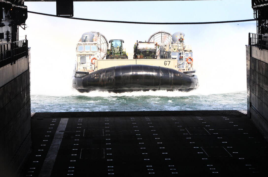 The Landing Craft Air Cushion carrying the vehicles destined for Maine’s 2012 Lobster Festival prepares to join the nearly 100 Marines and sailors of Combat Logistics Regiment 27, 2nd Marine Logistics Group aboard the USS San Antonio off the coast of Virginia, July 30, 2012. The troops aboard the ship will join the festivities from Aug. 1 to 5 to demonstrate their combined Marine-Navy capabilities to the American public. (Photo by Lance Cpl. Paul Peterson)