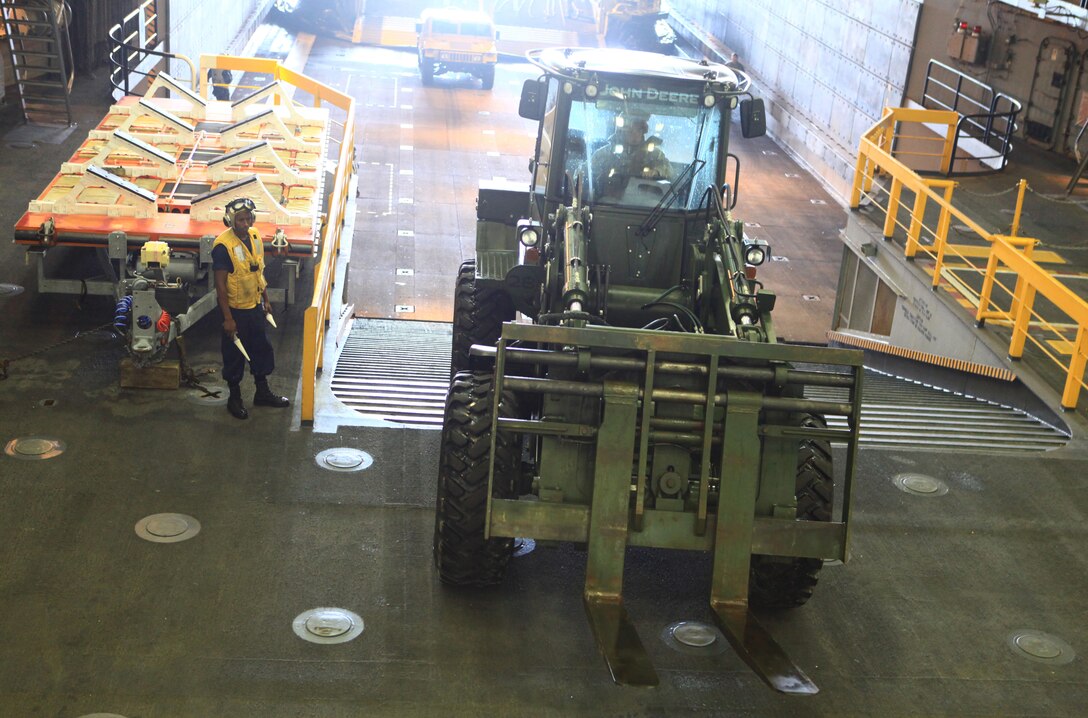 A multi-purpose tractor boards the USS San Antonio and joins nearly 100 Marines from Combat Logistics Regiment 27, 2nd Marine Logistics Group on their way to Maine’s 2012 Lobster Festival in Rockland, July 30, 2012. The vehicles and personnel aboard the San Antonio will provide the public with a unique, one-on-one opportunity to interact with the servicemembers and their equipment. (Photo by Lance Cpl. Paul Peterson)