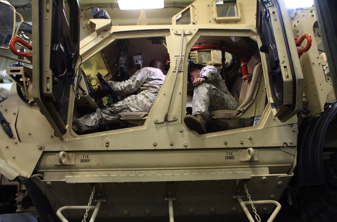 Gunnery Sgt. David Jackson and Cpl. Craig Turner, members of Combat Logistics Battalion 22, 2nd Marine Logistics Group, with the 2012 Lobster Festival detachment, review the controls of the Mine Resistant Ambush Protected – All Terrain Vehicle on their way to Rockland, Maine, July 31, 2012. The detachment’s personnel and equipment boarded the USS San Antonio in Norfolk, Va., and headed north to showcase the Marine-Navy capabilities for the public during the festival. (Photo by Lance Cpl. Paul Peterson)