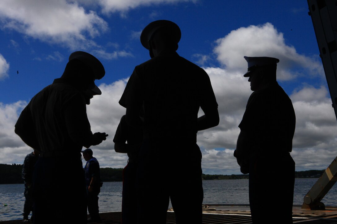 Marines with Combat Logistics Battalion 22, 2nd Marine Logistics Group aboard the USS San Antonio await their first ferry to Rockland, Maine, after a two-day voyage, Aug. 1, 2012. The Marines and sailors aboard the San Antonio joined with Maine’s 2012 Lobster Festival to demonstrate the Marine-Navy combined capabilities to the American public. (Photo by Lance Cpl. Paul Peterson)