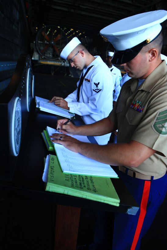 Marines and sailors with Combat Logistics Regiment 27, 2nd Marine Logistics Group sign out for their first day of liberty in Rockland, Maine,  aboard the USS San Antonio after their two-day voyage to Maine’s 2012 Lobster Festival, Aug. 1, 2012. The personnel aboard the ship will share their expertise and experiences with the public to demonstrate the Marine-Navy capabilities during the festival. (Photo by Lance Cpl. Paul Peterson)