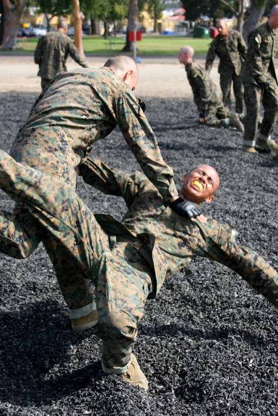 A recruit from Company H, 2nd Recruit Training Battalion, executes a leg sweep during the Combat Conditioning Exercise Aug. 1 aboard Marine Corps Recruit Depot San Diego. Leg sweeps allow one to quickly and effectively put their enemy on the ground. Recruits are taught the fundamentals of Marine Corps Martial Arts Program techniques and are required to execute them while in a stressful environment through the CCX. 