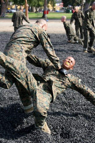A recruit from Company H, 2nd Recruit Training Battalion, executes a leg sweep during the Combat Conditioning Exercise Aug. 1 aboard Marine Corps Recruit Depot San Diego. Leg sweeps allow one to quickly and effectively put their enemy on the ground. Recruits are taught the fundamentals of Marine Corps Martial Arts Program techniques and are required to execute them while in a stressful environment through the CCX. 