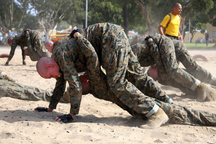 Recruits of Company H, 2nd Recruit Training Battalion, are taught different ways to transport a wounded comrade during battle. The buddy bear crawl allows one to keep a low silhouette while dragging the injured to a safe environment.