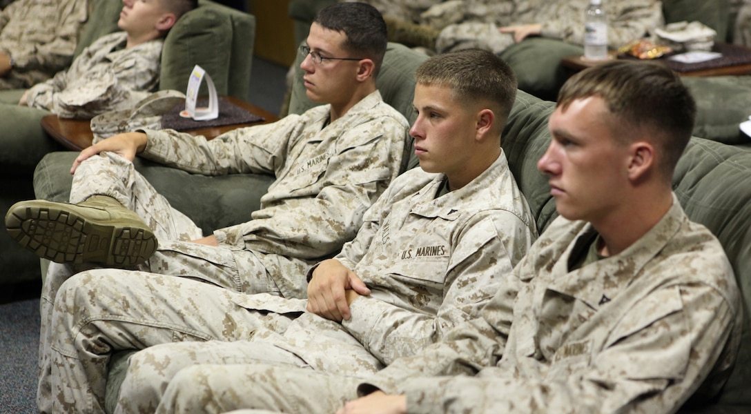 Marines from Headquarters and Support Battalion are attentive during a Never Leave a Marine Behind course, a suicide prevention class for members of the Marine Corps Aug. 2. The Marines watched a multimedia presentation and had a guided discussion.