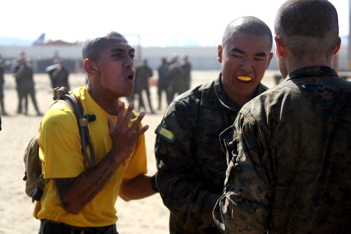 Sgt. Omar Garcia, drill instructor, Platoon 2161, Company H, 2nd Recruit Training Battalion, corrects his recruits on properly performing techniques during the Combat Conditioning Exercise Aug. 1 aboard Marine Corps Recruit Depot San Diego. Drill instructors cause a stressful environment for the recruits while they are expected to perform Marine Corps Martial Arts Program techniques.