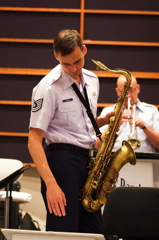 YOKOTA AIR BASE, Japan -- Tech. Sgt. Ricky Sweum, Band of the Pacific-Asia saxophonist, references a musical example while explaining a piece of music to the Pacific Showcase jazz ensemble at the Band of the Pacific-Asia, Yokota Air Base, Japan, Aug. 6, 2012. Sweum spent many hours prior to the ensemble’s first rehearsal preparing musical selections for the group to perform.  (U.S. Air Force photo/Senior Airman Brian Lumpkin)