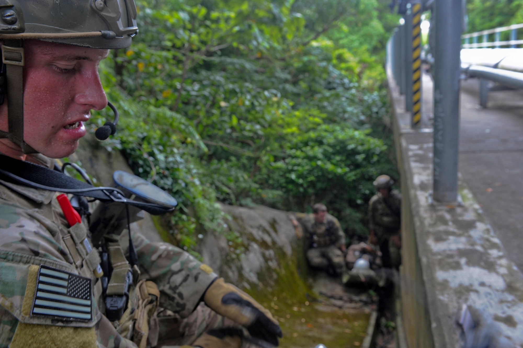 U.S. Air Force Staff Sgt. Joseph Mott, 31st Rescue Squadron pararescueman, pulls a mock victim to a safety point during a technical rescue element leader upgrade scenario on Kadena Air Base, Japan, Aug. 3, 2012. This upgrade training evaluates a pararescuemen's ability to transition from being a part of the group to leading the group. (U.S. Air Force photo/Airman 1st Class Justin Veazie)