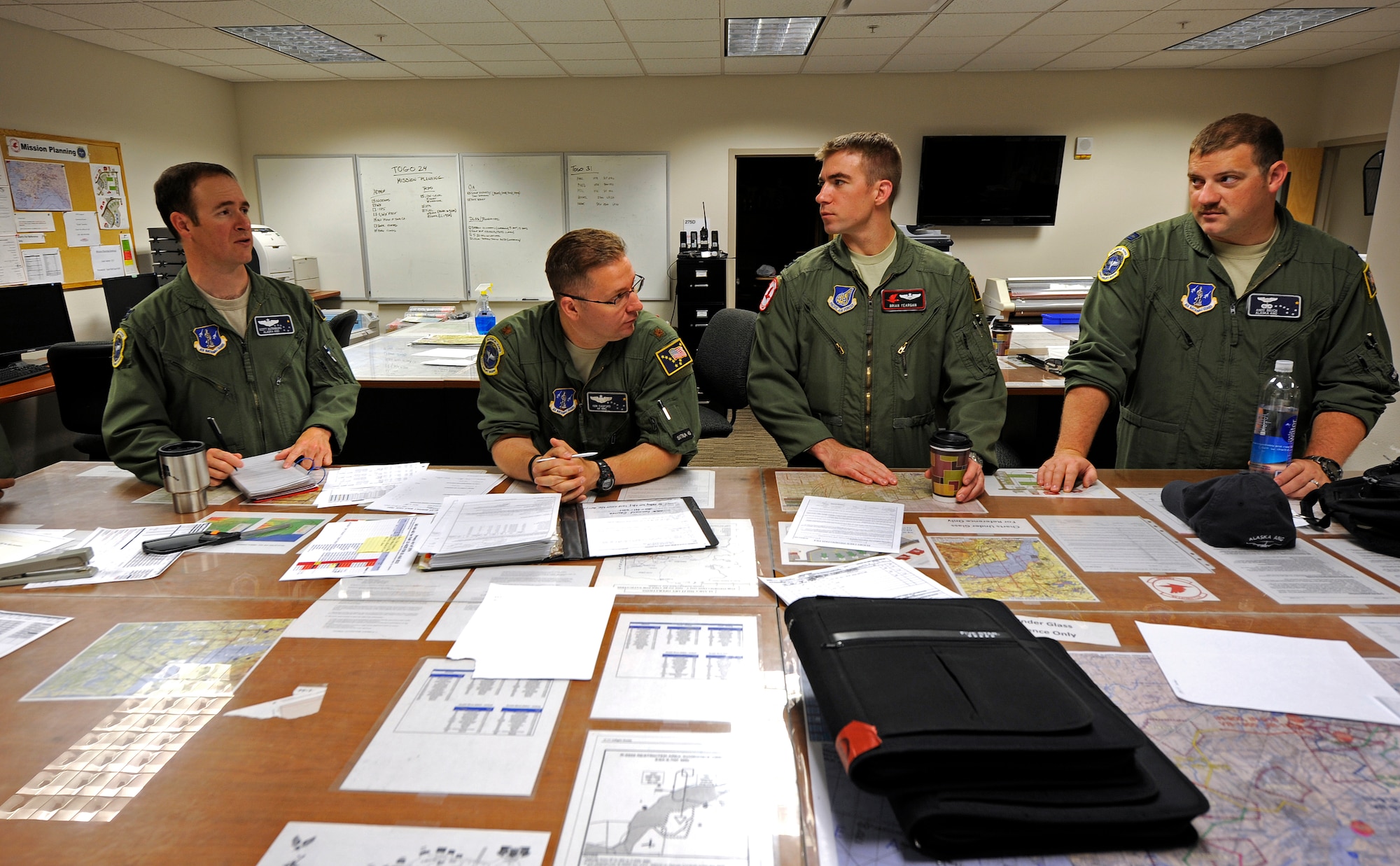 Alaska Air National Guard members from the 249th Airlift Squadron and active duty members from the 517th AS take part in a flight brief at the 517th AS, Aug. 3, 2012, prior to a flight to Hill Air Force Base, Utah. The combined Alaska ANG and JBER active-duty aircrew provided a team of JBER reservists airlift to Hill so they could participate in the upcoming Combat Hammer exercise. (U.S. Air Force photo/Tech. Sgt. Brian Ferguson)