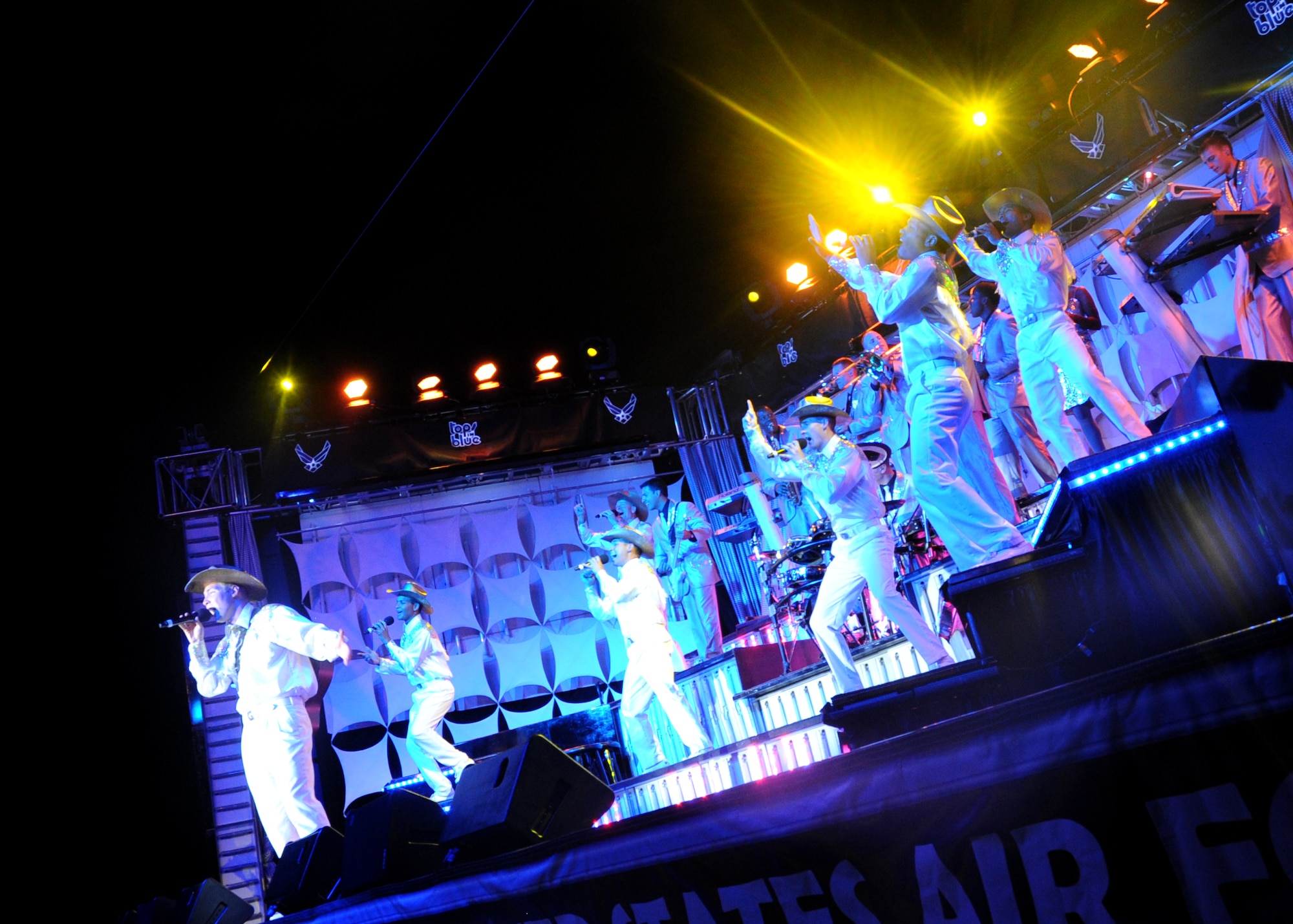 ALTUS AIR FORCE BASE, Okla. – Airmen from the Air Force group Tops in Blue sing during a concert held at Wings of Freedom Park, Aug. 4, 2012. Tops in Blue has traveled all over the world, performing over 7,000 shows since 1953. (U.S. Air Force photo by Airman 1st Class Levin Boland / 97th Air Mobility Wing / Released)