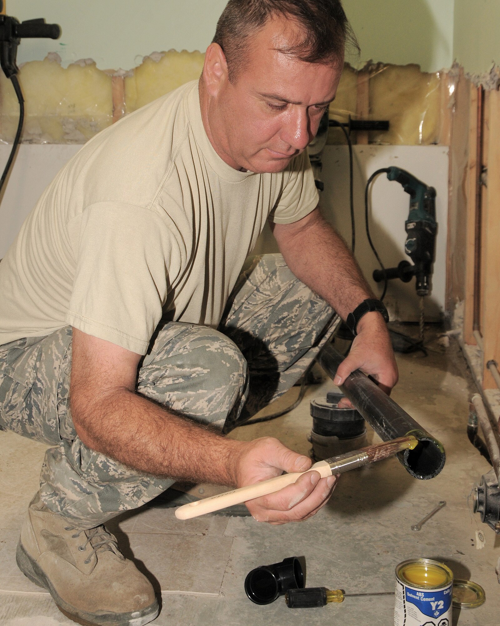 Tech. Sgt. Howard Alger prepares piping he will use to connect a sink to the main drainage line in a bathroom at the Canadian Forces base preschool in Cold Lake, Alberta The 146th Airlift Wing Civil Engineering Squadron, Channel Islands Air National Guard Station, Port Hueneme, Calif. performed their annual training at Canadian Forces Base, Cold Lake, Alberta, Canada July 28-Aug. 11, 2012, taking on several ventures, including a renovation at a children’s day care center and a grading project for a concrete storage compound to support sea containers. (U.S. Air Force photo by Tech. Sgt. Alex Koenig)