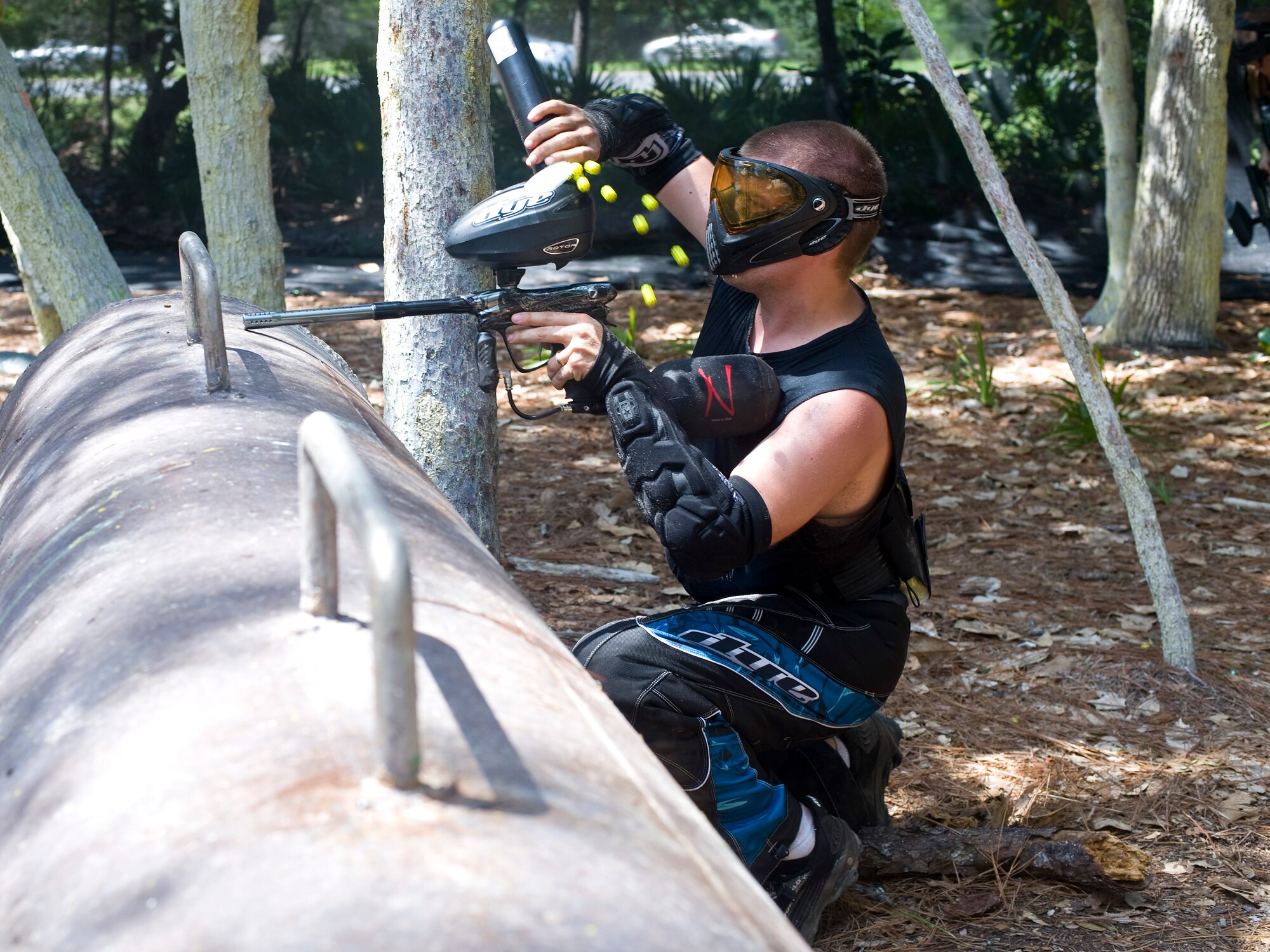 U.S. Air Force Senior Airman Samuel Smith, a flightline avionics journeyman of the 1st Special Operations Maintenance  Squadron, reloads his paintball gun during the chief?s and Airmen?s paintball challenge at Hurlburt Field?s paintball field at Hurlburt Field, Fla., July 27, 2012. The chiefs played as a chance to connect with junior enlisted members. (U.S. Air Force photo/Airman 1st Class Michelle Vickers)
