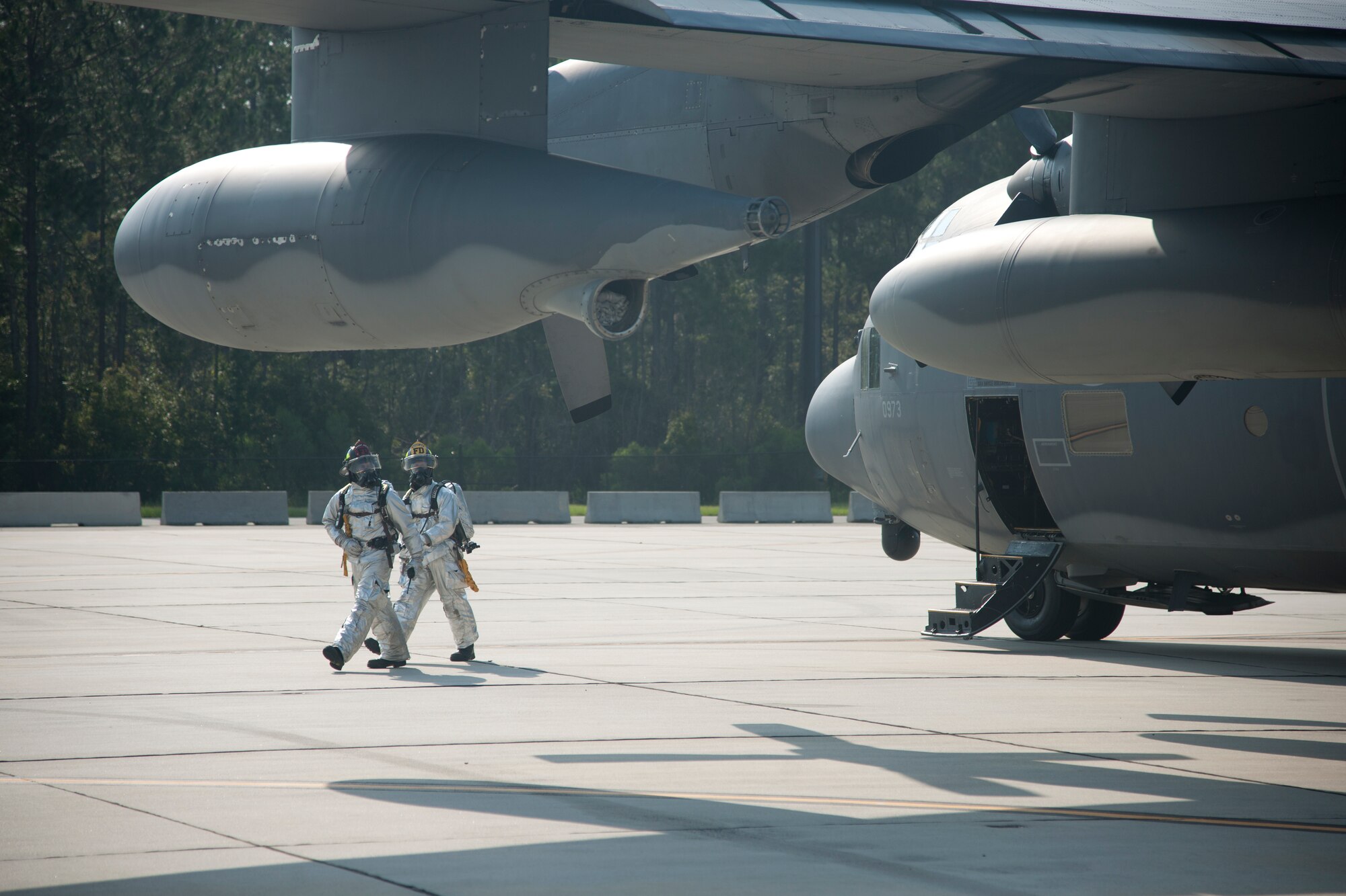 The 23d Civil Engineer Squadron firefighters arrive on the scene during a weapons exercise at Moody Air Force Base, Ga., Aug. 3, 2012. The firefighters inspected the surroundings of an HC-130P Combat King to ensure the area was safe sand secure. (U.S. Air Force photo by Airman 1st Class Paul Francis/Released)
