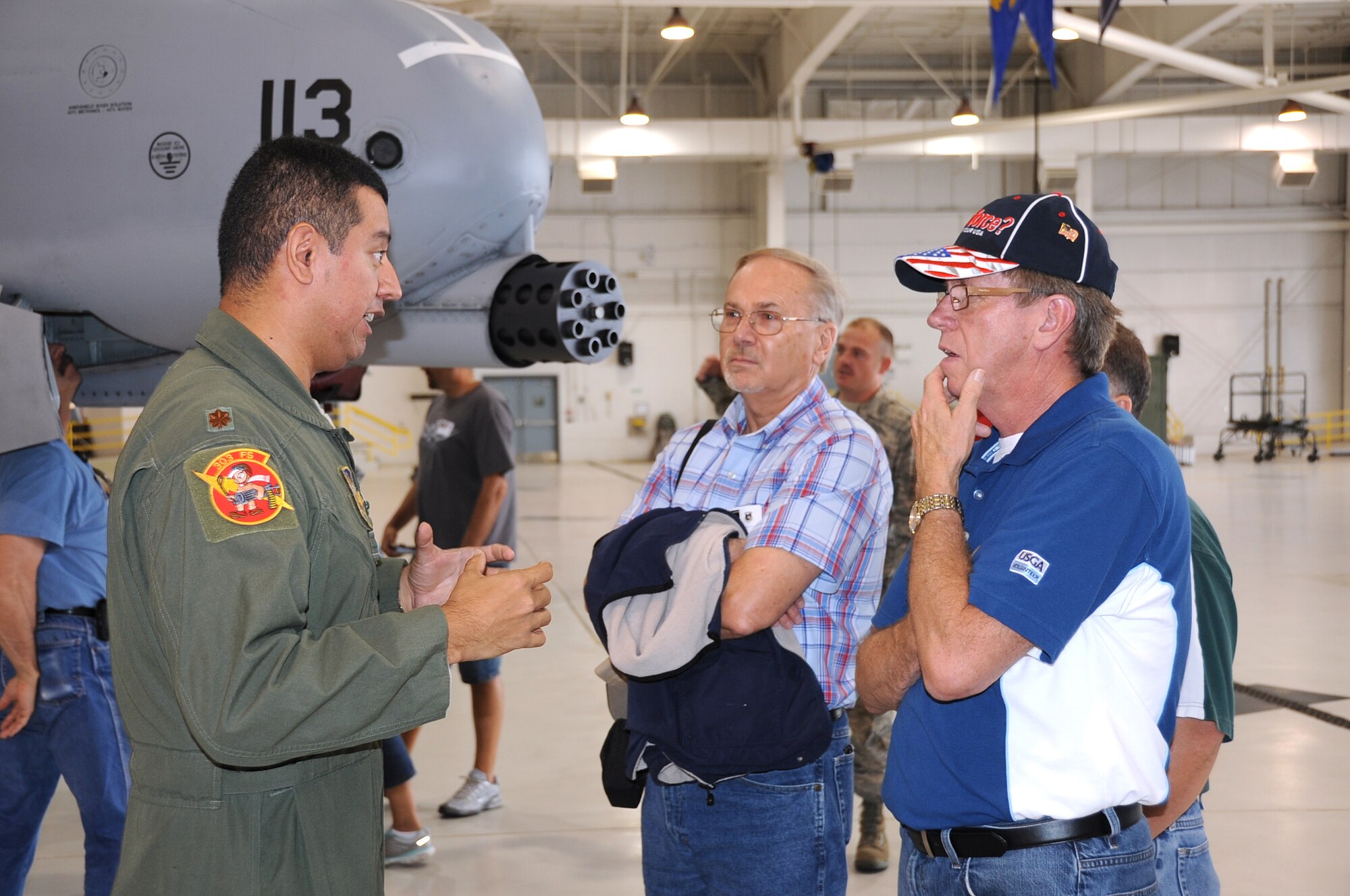 A-10 Thunderbolt II pilot Maj. Abel Ramos, 303rd Fighter Squadron, answers questions about the A-10 to civilian employers of 442nd Fighter Wing reservists during Employer Day, Aug. 4, 2012 here. Employer Day allows the civilian employers of Air Force reservists the opportunity to see what their employees do on their Reserve weekend as well as thank the employees for their flexibility and support. The 303 FS is assigned to the 442 FW, an Air Force Reserve unit stationed at Whiteman Air Force Base Mo. (U.S. Air Force photo/Staff Sgt. Lauren Padden)