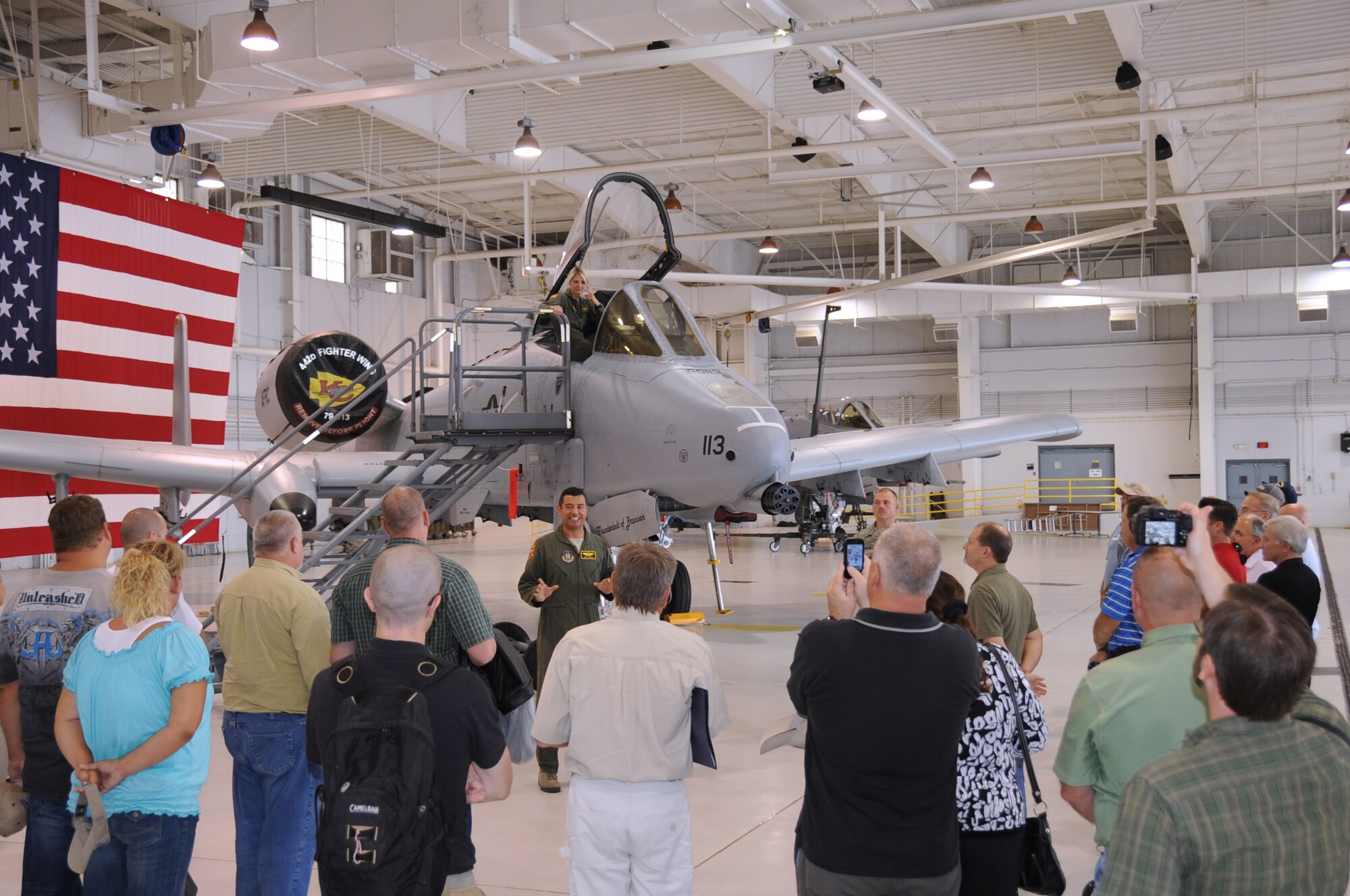 WHITEMAN AIR FORCE BASE, Mo. -- A-10 Thunderbolt II pilot Maj. Abel Ramos, 303rd Fighter Squadron, describes the attributes and fire power of the A-10 to civilian employers of 442nd Fighter Wing reservists during Employer Day, Aug. 4, 2012 here. Employer Day allows the civilian employers of Air Force reservists the opportunity to see what their employees do on their Reserve weekend as well as thank the employees for their flexibility and support. The 303 FS is part of the 442 FW, an Air Force Reserve unit at Whiteman Air Force Base Mo. (U.S. Air Force photo/Staff Sgt. Lauren Padden)
