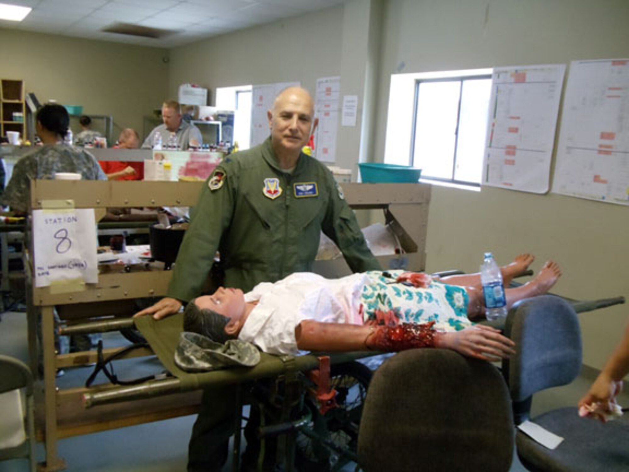 Col. (Dr.) Robert Todaro, Air Forces Northern Command Surgeon, with a moulaged "patient" at the Vibrant Response 13 exercise.  The exercise, held primarily at Camp Atterbury, Ind.,  is meant to test the response capability of the Department of Defense chemical, biological, radiological and nuclear (CBRN) response force (DCRF). (Photo by Daizy Labee)
