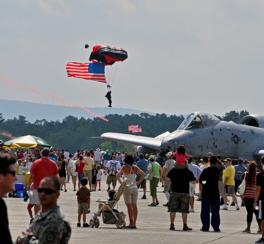 A Black Dagger jumper floats down with the flag during the opening ceremonies. The Air Show this year is the largest Westover has had since 1974, boasting more than 60 aircraft. (U.S. Air Force photo/MSgt. Andrew Biscoe)