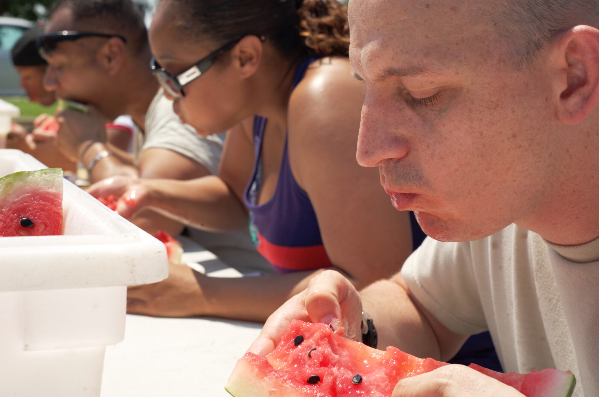 U.S. Air Force Tech. Sgt. Stewart Soper, 633rd Communications Squadron communications security accountant, gorges on watermelon during an eating contest at the 2012 Langley-Eustis Appreciation Day at Langley Air Force Base, Va., Aug. 3, 2012. Base units and organizations conduct LEAD annually to provide food and fun for hardworking junior enlisted Service members. (U.S. Air Force photo by Tech. Sgt. Barry Loo/Released)
