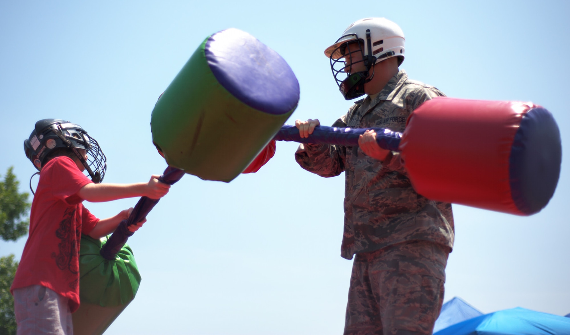 U.S. Air Force Staff Sgt. Aaron Shifflett, 633rd Communications Squadron client systems technician, jousts with his son Casen, 8, during the 2012 Langley-Eustis Appreciation Day at Langley Air Force Base, Va., Aug. 3, 2012. Base units and organizations conduct LEAD annually to provide food and fun for hardworking junior enlisted Service members. (U.S. Air Force photo by Tech. Sgt. Barry Loo/Released)