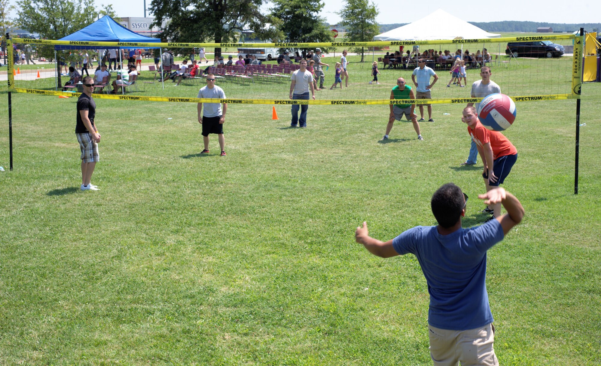 Service members and family play volleyball during the 2012 Langley-Eustis Appreciation Day at Langley Air Force Base, Va., Aug. 3, 2012. Base units and organizations conduct LEAD annually to provide food and fun for hardworking junior enlisted Service members. (U.S. Air Force photo by Tech. Sgt. Barry Loo/Released)