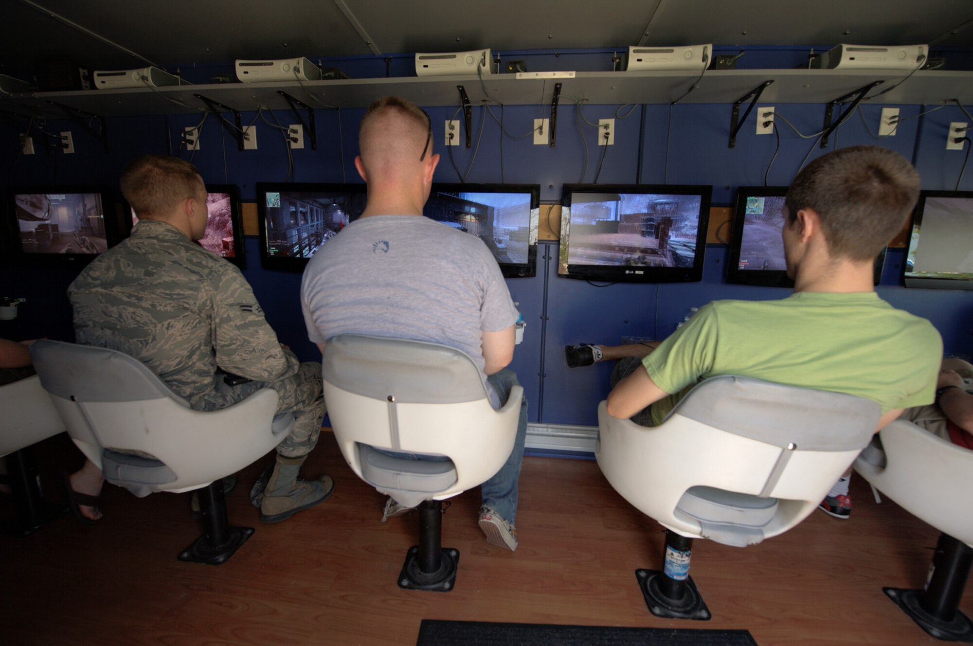 U.S. military personnel and family members play a networked video game during the 2012 Langley-Eustis Appreciation Day at Langley Air Force Base, Va., Aug. 3, 2012. Base units and organizations conduct LEAD annually to provide food and fun for hardworking junior enlisted Service members. (U.S. Air Force photo by Tech. Sgt. Barry Loo/Released)