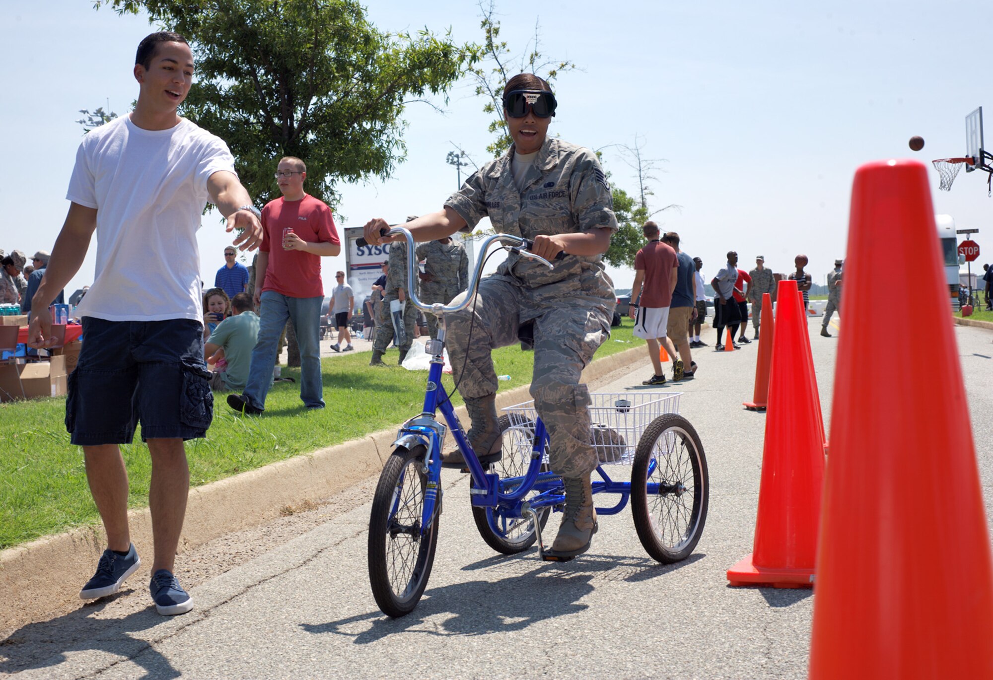 U.S. Air Force Senior Airman Jose Osuna, 633rd Medical Operations Squadron, guides Staff Sgt. Moriah Miravalles through a simulated-drunk driving course during the 2012 Langley-Eustis Appreciation Day at Langley Air Force Base, Va., Aug. 3, 2012. The event provided an opportunity for military personnel and family members from Langley and Eustis to enjoy food and a wide range of activities. (U.S. Air Force photo by Tech. Sgt. Barry Loo/Released)
