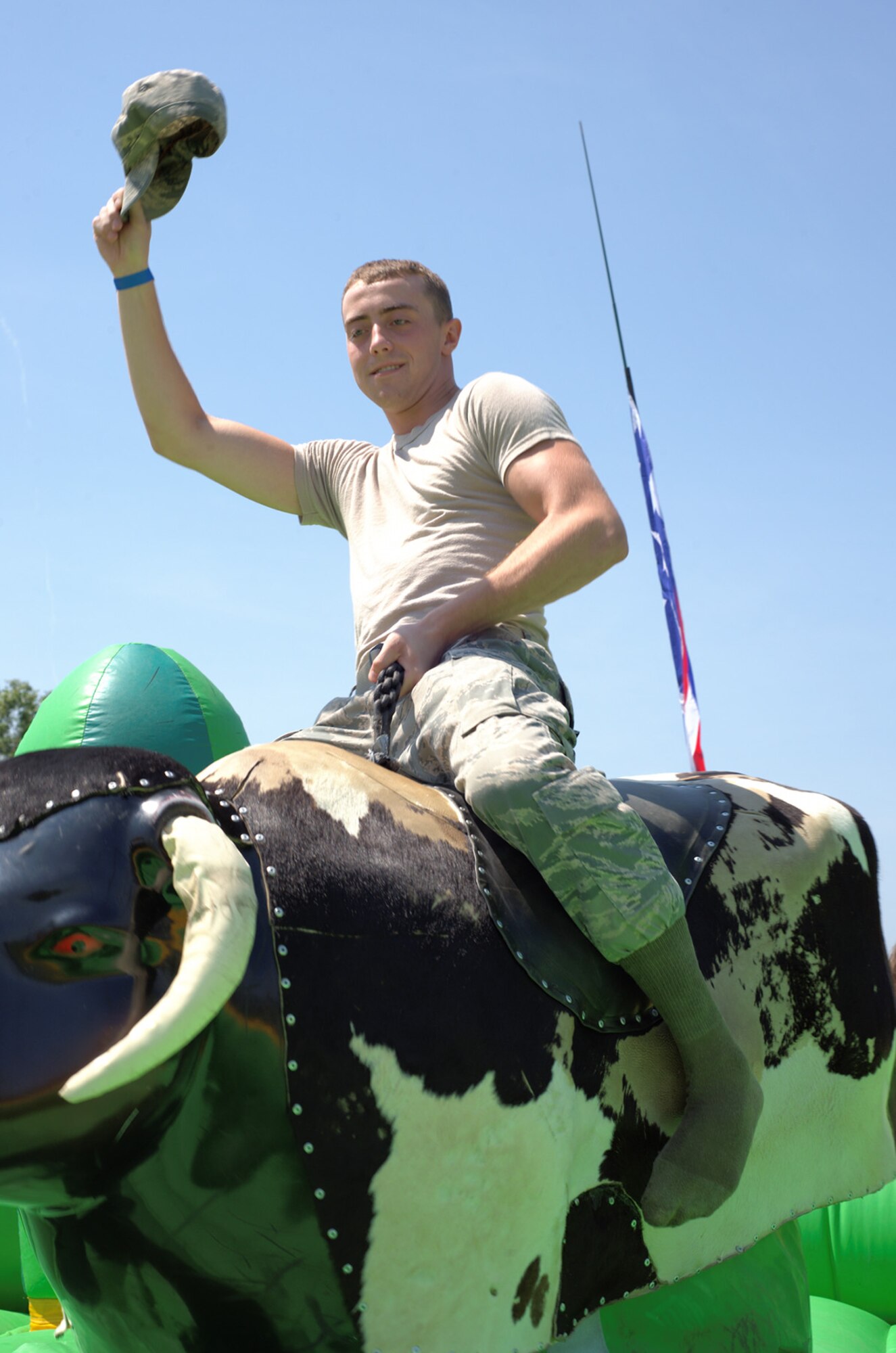 U.S. Air Force Airman 1st Class Chad Owens, 633rd Medical Support Staff nutritional medicine craftsman, rides a mechanical bull during the 2012 Langley-Eustis Appreciation Day at Langley Air Force Base, Va., Aug. 3, 2012. Agencies across the base joined forces to provide a day of food, fun and entertainment to thank military personnel for their daily contributions toward accomplishing the mission of Joint Base Langley-Eustis. (U.S. Air Force photo by Tech. Sgt. Barry Loo/Released)
