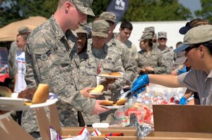 Volunteers serve food to U.S. military personnel and their family members during the 2012 Langley-Eustis Appreciation Day at Langley Air Force Base, Va., Aug. 3, 2012. Agencies across the base joined forces to provide a day of food, fun and entertainment to thank military personnel for their daily contributions toward accomplishing the mission of Joint Base Langley-Eustis. (U.S. Air Force photo by Tech. Sgt. Barry Loo/Released)