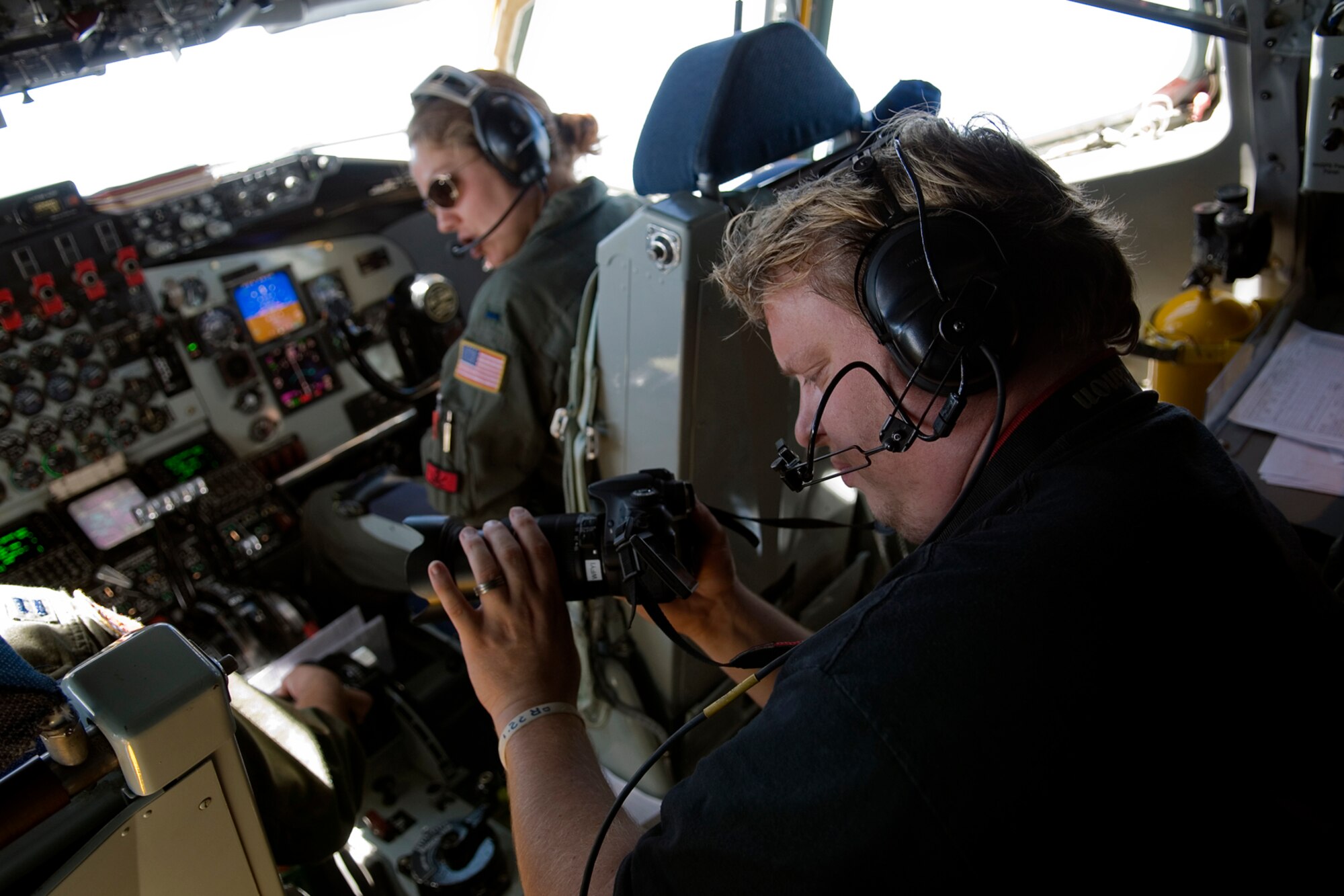 GRISSOM AIR RESERVE BASE, Ind. -- Aric Hartvig, an Indianapolis television producer, takes footage inside the cockpit of a KC-135R Stratotanker during an ariel refueling mission here Aug. 1. The refueling mission gave crew members from both aircraft hands on training in aerial refueling to keep them ready for any mission around the globe. The mission also gave local media the chance to get up close and see a refueling mission take place. (U.S. Air Force photo/Senior Airman Jami K. Lancette)