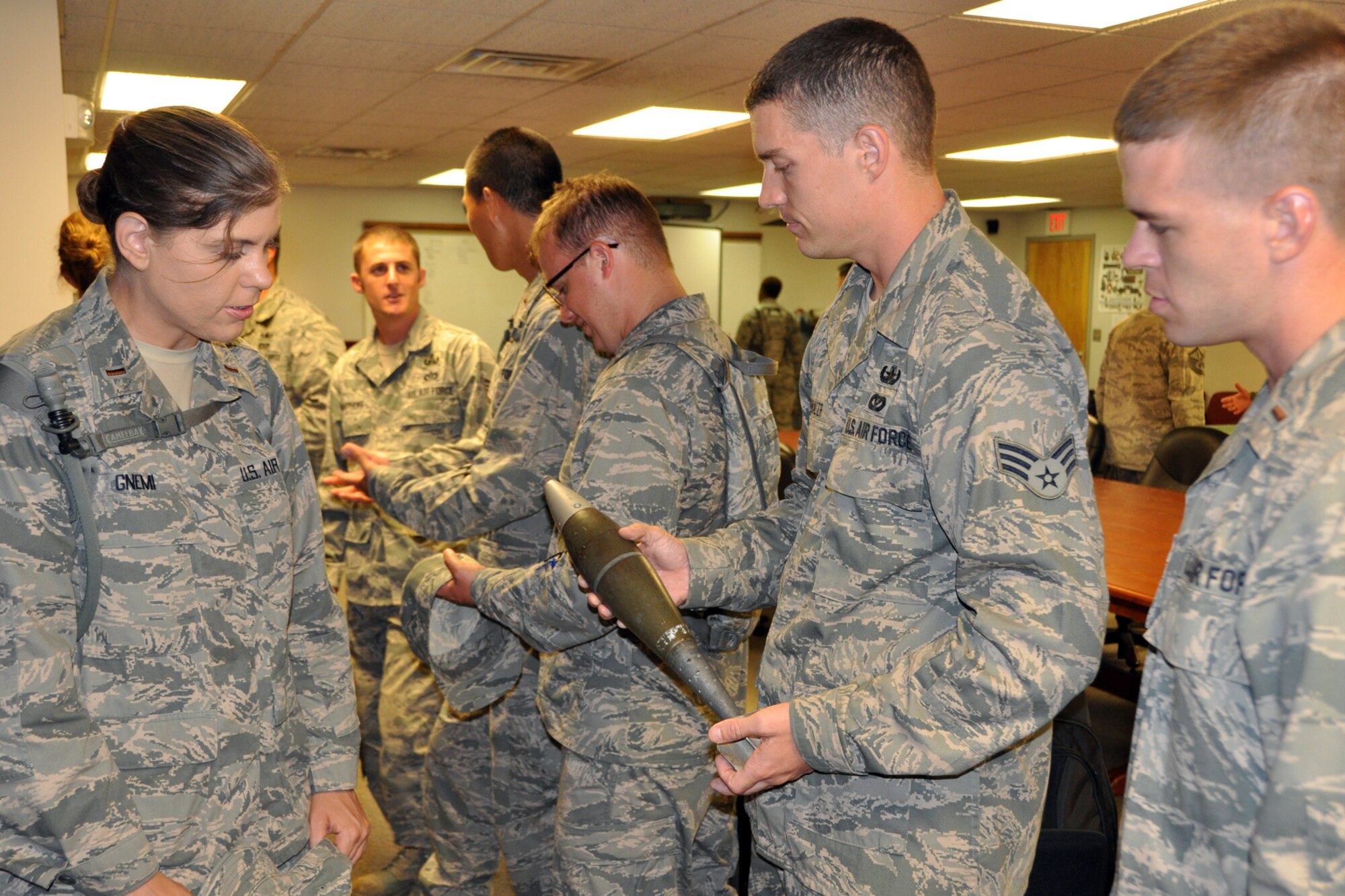 Senior Airman Jerrad Showalter, an explosive ordnance disposal technician, 307th Civil Engineer Squadron, discusses an 81mm mortar round with Chaplain Candidate 2nd Lt. Amber Gnemi in the EOD complex at Barksdale Air Force Base, La., July 31, 2012. A tour of the EOD complex was part of The Chaplain Candidate Intensive Internship program’s visit to Barksdale from July 27 to Aug 2, 2012. (U.S. Air Force photo by Master Sgt. Jeff Walston)