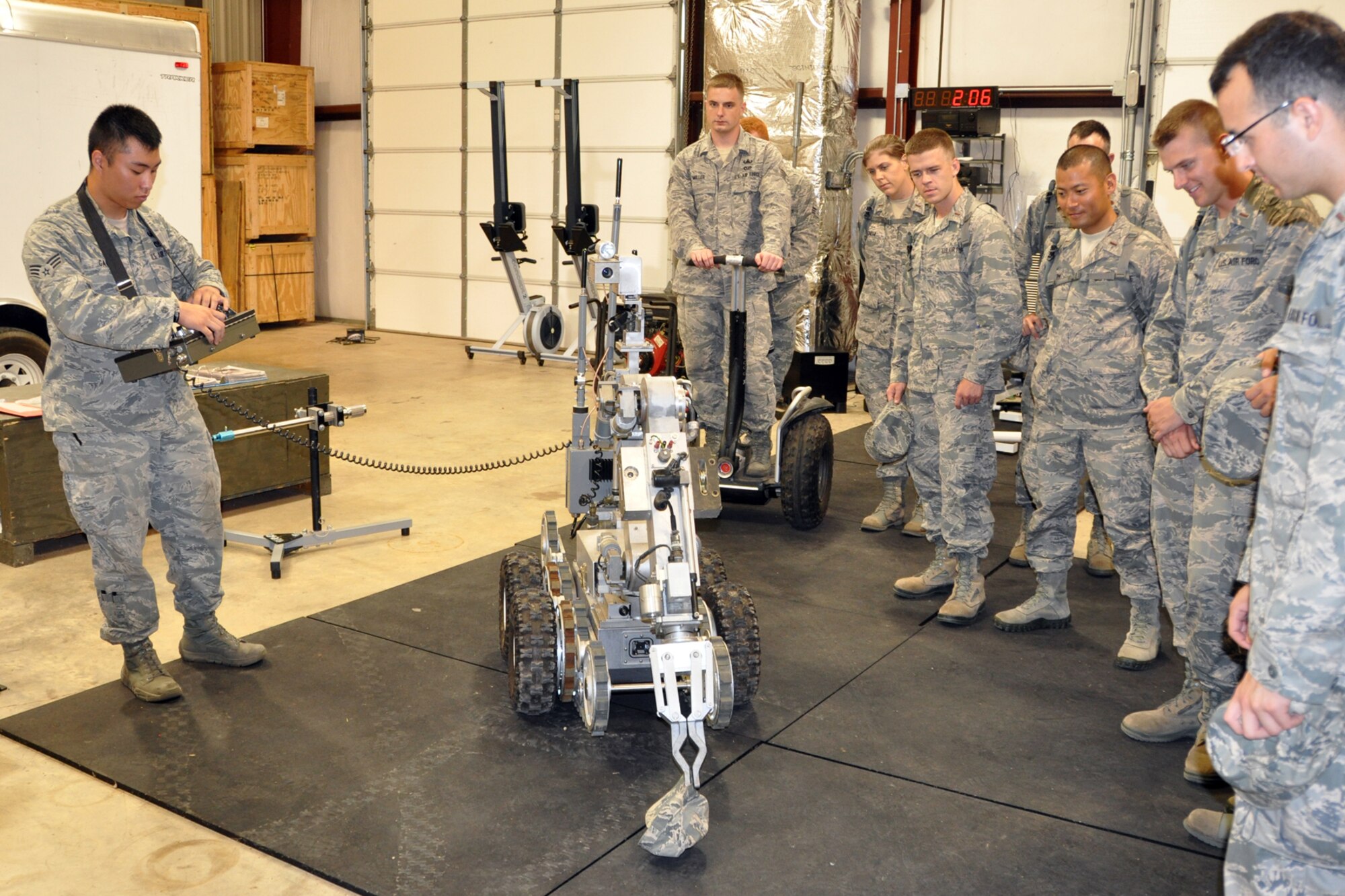 Senior Airman Alex Gaunt, an explosive ordinance disposal technician assigned to the 2nd Civil Engineer Squadron, demonstrates the F6A Robot for a group of Chaplain Candidates in the EOD complex at Barksdale Air Force Base, La., July 31, 2012. The robot is used to help identify and deal with explosive hazards at a distance without placing Airmen and indigenous personnel at risk. (U.S. Air Force photo by Master Sgt. Jeff Walston)