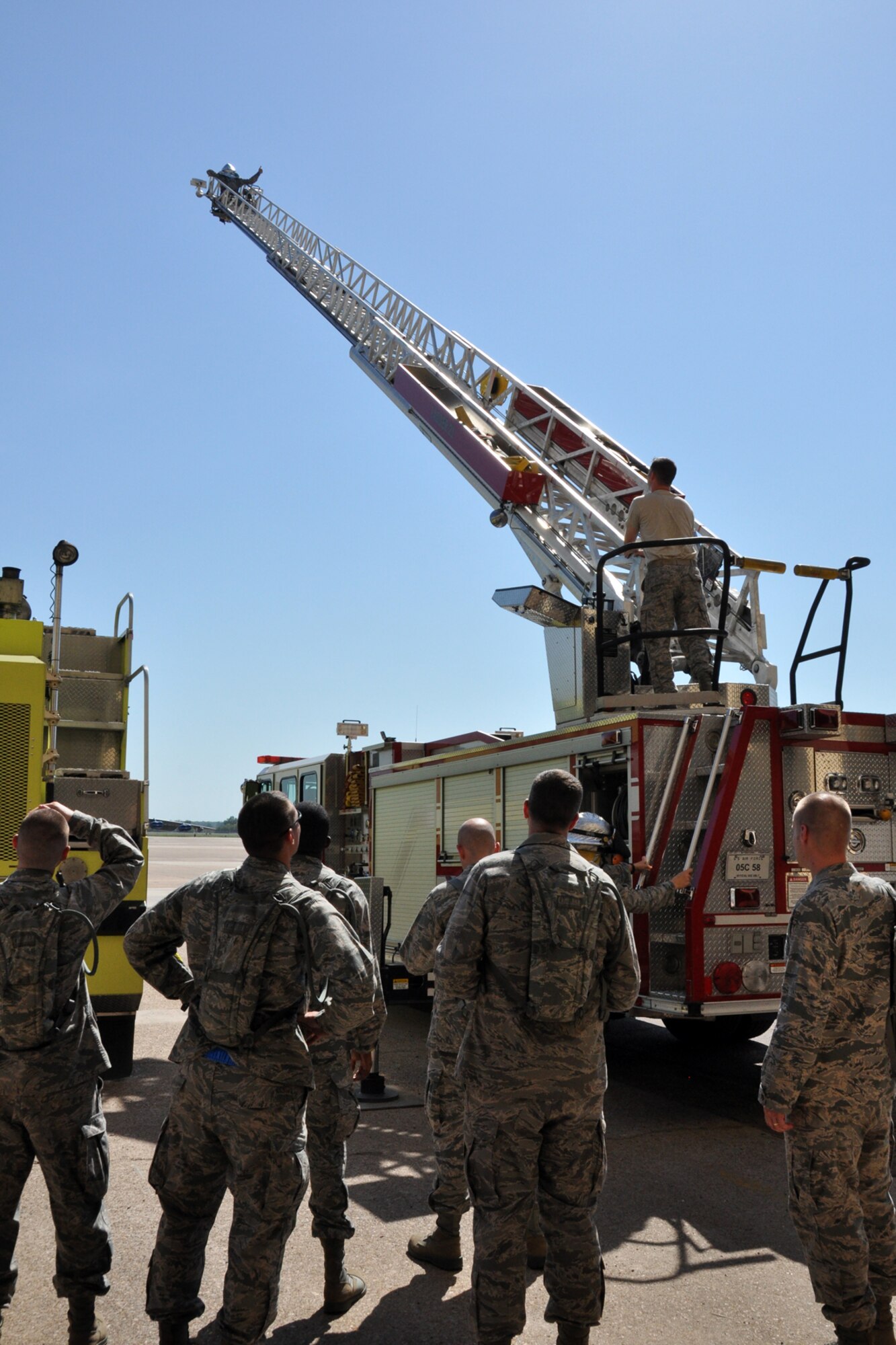 Staff Sgt. Steven O’Brien, a firefighter assigned to the 2nd Civil Engineer Squadron, receives a thumbs-up sign from Chaplain Candidate 2nd Lt. Daniel Fairchild at the top of Ladder 21 on Barksdale Air Force Base, La., July 31, 2012. The thumbs up signals that radio communications have been established between the two Airmen, or that Fairchild is “locked in, safe and good to go.” (U.S. Air Force photo by Master Sgt. Jeff Walston)