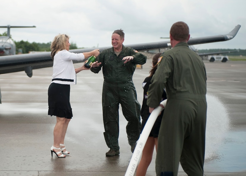 Air Force Reserve Col. Pat Ryan, former 5th Special Operations Squadron commander, reacts to a traditional shower of champagne from his wife Teresa and a fire hose blast of water from family and fellow Airmen well-wishers celebrating his recent fini flight at Hurlburt Field, Fla.   The occasion marked his final flight as an Air Force pilot.   Ryan, who took command of the 5th SOS in March 2011 has moved on to serve as an individual mobilization augmentee at Headquarters Air Force Special Operations Command. (U.S. Air Force photo/Airman 1st Class Hayden Hyatt)