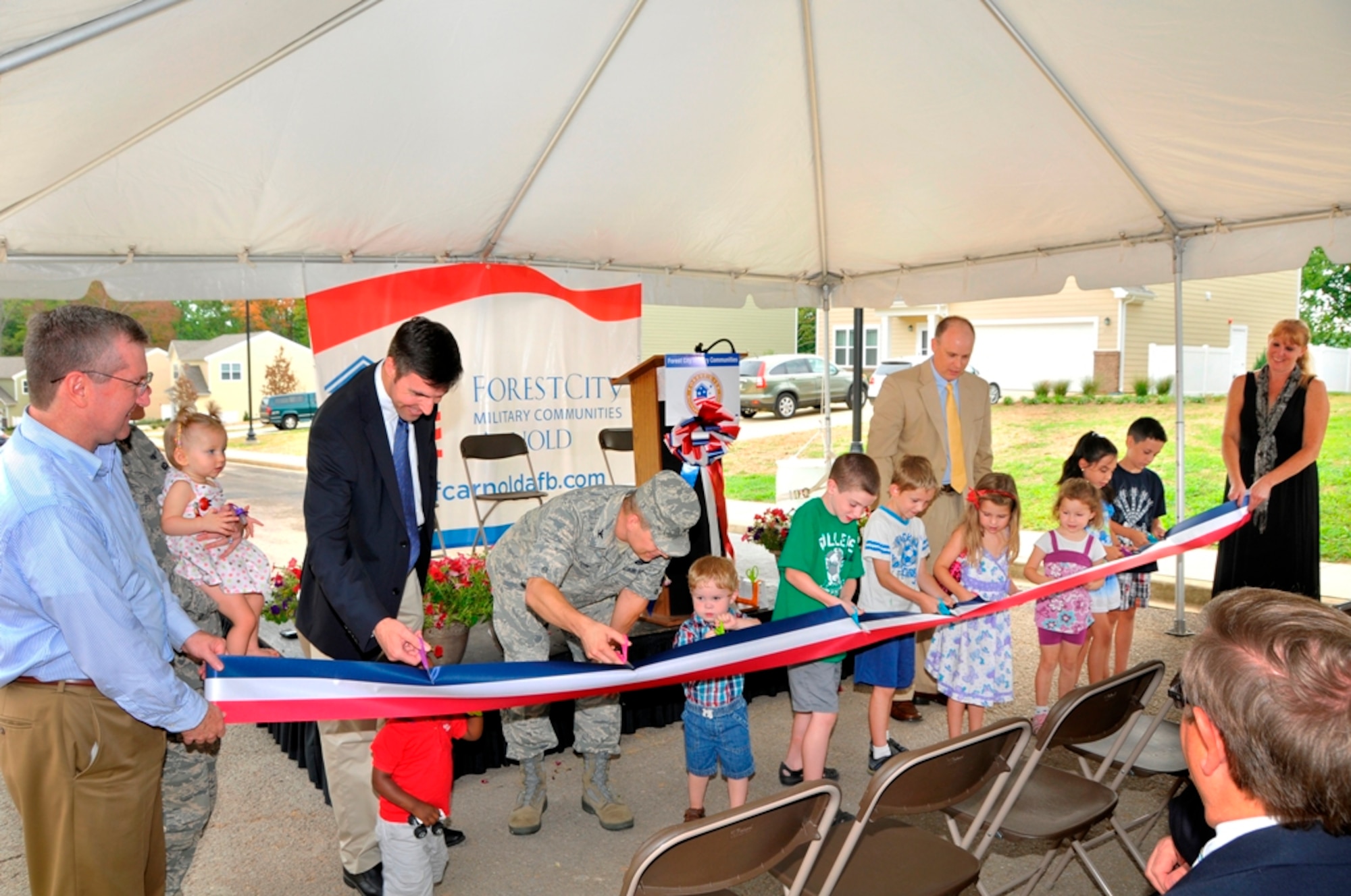 Children who will live in the 14 new homes that make up Arnold AFB’s new on-base housing cut the ribbon during a dedication ceremony July 31. (Photo by Jacqueline Cowan)