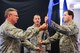 Col. Norm Brosi, left, commander of the 139th Airlift Wing’s Mission Support Group, hands Maj. Greg Roberts the guidon for the 139th Security Forces Squadron during an assumption of command ceremony August 4, 2012 at Rosecrans Air National Guard Base, St. Joseph, Mo.  Roberts assumed command after more than 20 years of service.  (U.S. Air Force photo/Senior Airmen Kelsey Stuart)