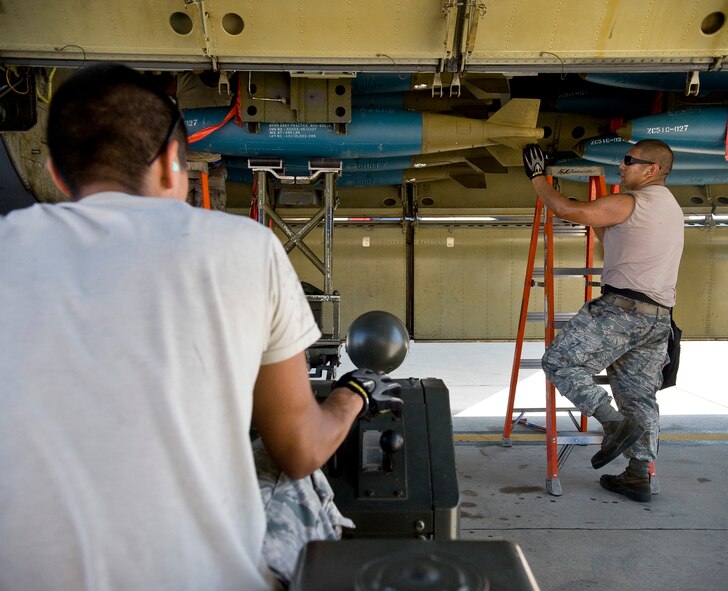 Senior Airman Robert Cavazos, 2nd Munitions Squadron weapons load crew two man, guides a BDU-50 inert bomb into place in the bomb bay of a B-52H Stratofortress on Barksdale Air Force Base, La., Aug. 3. The combined efforts of the 2nd Maintenance Group units resulted in July being the most successful maintenance month here in 16 years. (U.S. Air Force photo/Staff Sgt. Chad Warren)(RELEASED)
