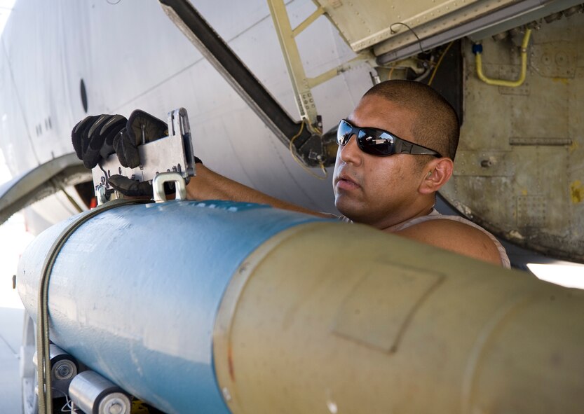 Senior Airman Robert Cavazos, 2nd Munitions Squadron weapons load crew two man, attaches a B-11 shackle to a BDU-50 inert bomb on Barksdale Air Force Base, La., Aug. 3. The combined efforts of the 2nd Maintenance Group units resulted in July being the most successful maintenance month here in 16 years. (U.S. Air Force photo/Staff Sgt. Chad Warren)(RELEASED)