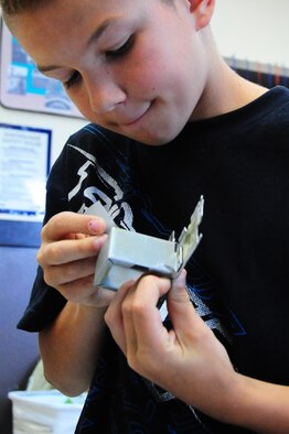Son of U.S. Air Force Staff Sgt. Donald Slayton, 35th Maintenance Squadron, builds a dragon out of broken radio pieces at the Cheli School-Age Program, Misawa Air Base, Japan, Aug. 6, 2012.  Cheli’s program has a variety of age-specific rooms for children to play games, draw, read or relax.  (U.S. Air Force photo by Staff Sgt. April Quintanilla)