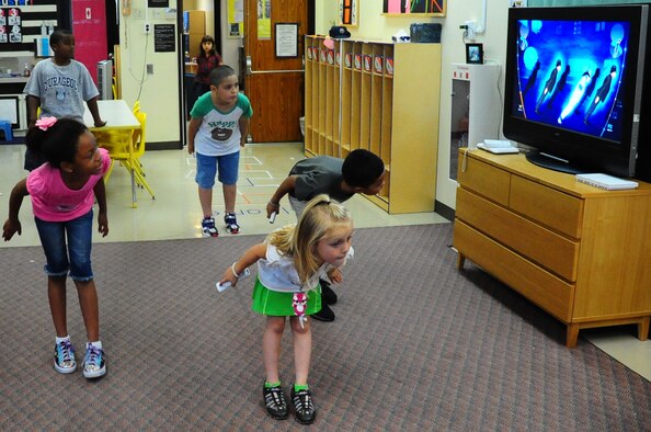 Children play a video game while attending Cheli School-Age Program at Misawa Air Base, Japan, Aug. 6, 2012.  The program offers numerous clubs for children such as: a cooking club, fun fit club, book club and art club.  Cheli’s program opens fall registration for non-members on August 13 through 24. (U.S. Air Force photo by Staff Sgt. April Quintanilla)
