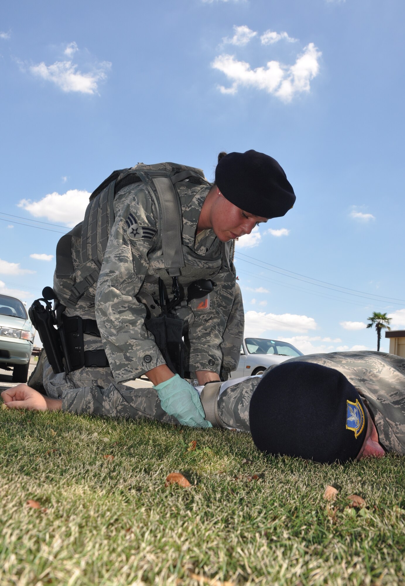 YOKOTA AIR BASE, Japan -- Senior Airman Madeline Salton, 374th Security Forces Squadron patrolman, stabilizes a simulated object in the arm of a simulated patient during an exercise outside the 374 SFS armory Aug. 2, 2012 at Yokota Air Base, Japan. Self-aid and buddy care exercises are one of hundreds of different exercises conducted on a daily basis to help keep security forces members ready and alert to respond to any situation that may arise. (U.S. Air Force photo by Senior Airman Katrina R. Menchaca)