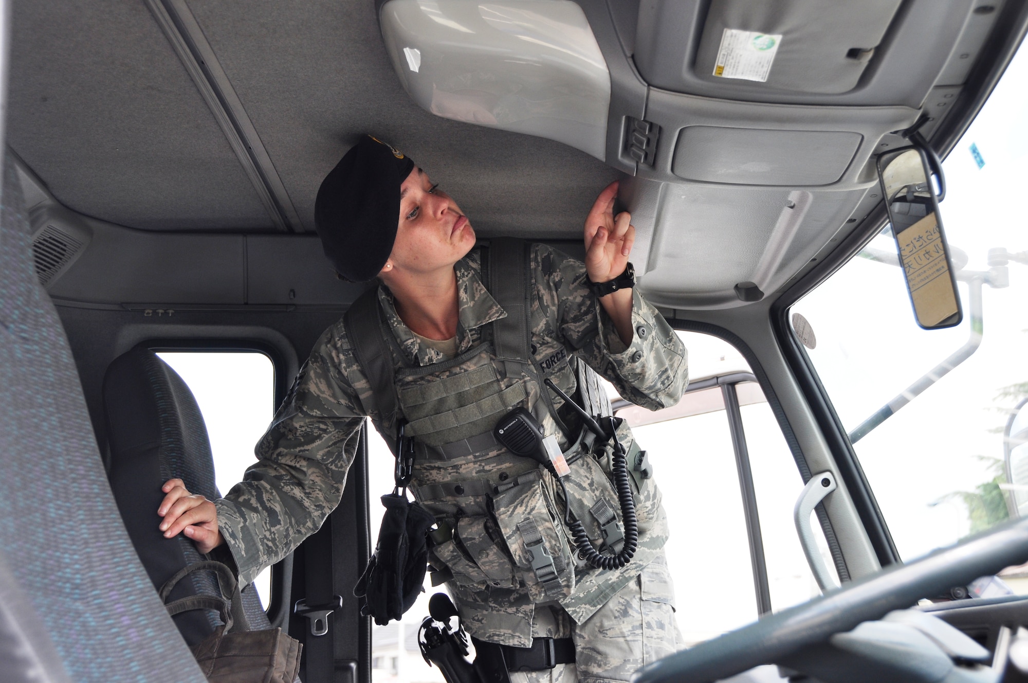 YOKOTA AIR BASE, Japan -- Senior Airman Madeline Salton, 374th Security Forces Squadron patrolman, inspects the interior of a delivery truck during a random vehicle inspection outside the supply gate Aug. 2, 2012 at Yokota Air Base, Japan. Salton looked for any items that could pose a threat to base security or the safety of base residents. (U.S. Air Force photo by Senior Airman Katrina R. Menchaca)