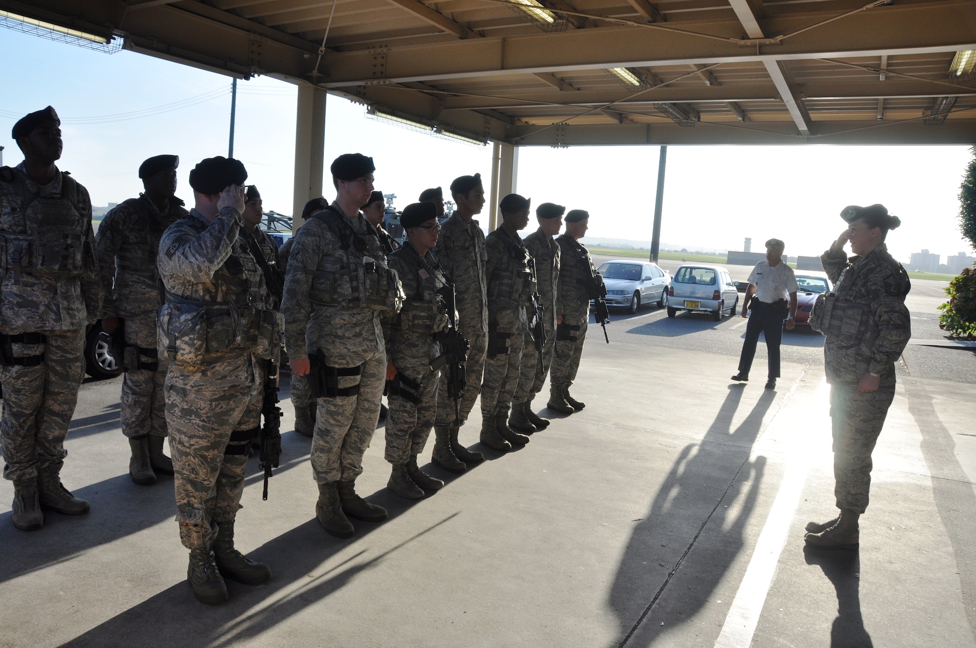 YOKOTA AIR BASE, Japan -- Members of the 374th Security Forces Squadron alpha flight prepare for an open ranks inspection at the beginning of their shift Aug. 2, 2012 at Yokota Air Base, Japan. Inspections are conducted to check for uniform and gear discrepancies, looking for loose strings or misplaced gear which could create a safety concern during their shift. (U.S. Air Force photo by Senior Airman Katrina R. Menchaca)