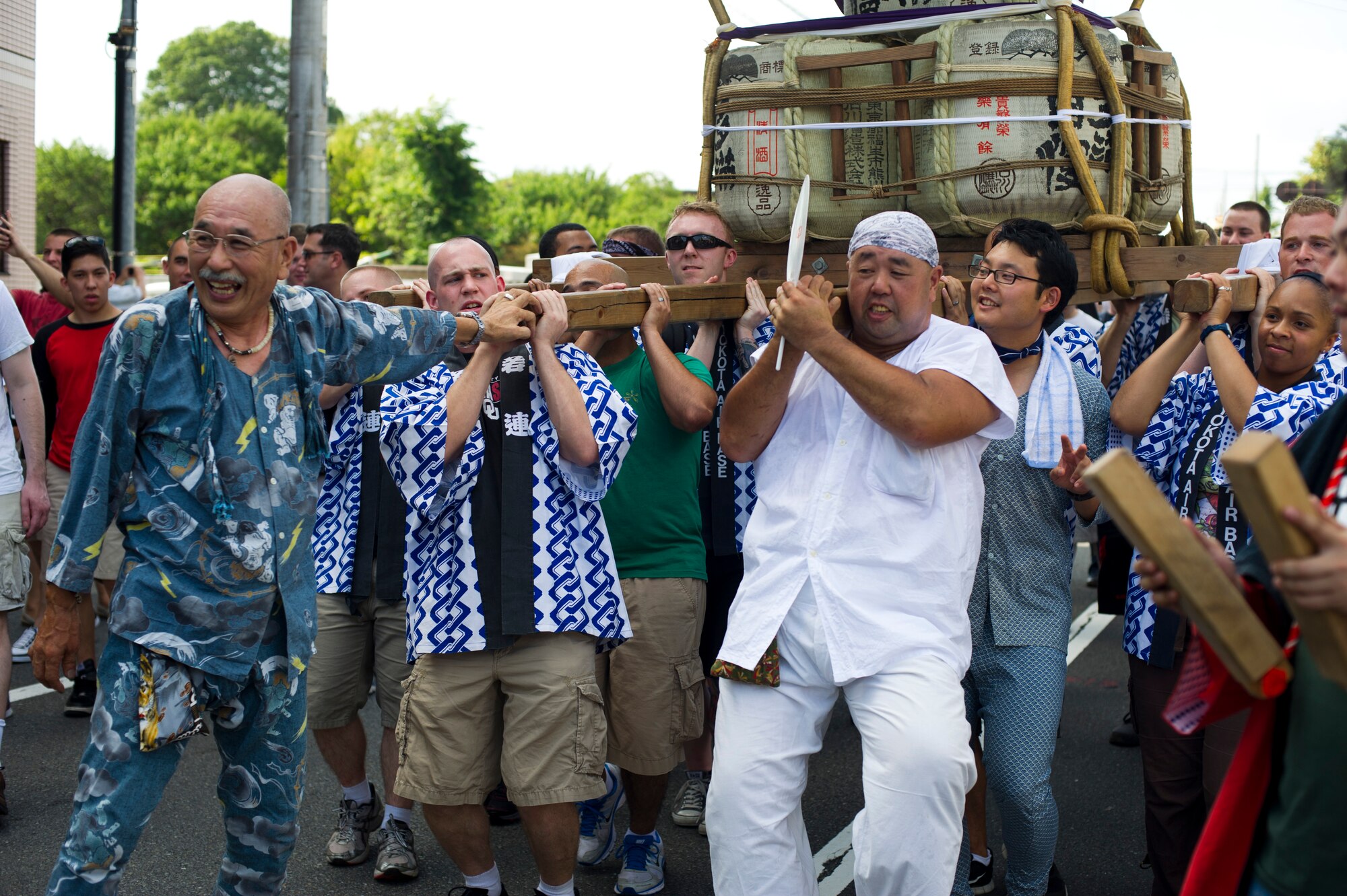 FUSSA CITY, Japan -- Military members from Yokota Air Base carry a mikoshi shrine during the Fussa Tanabata Festival in Fussa City, Japan, Aug. 3, 2012. At many points during the mikoshi parade, the various groups carrying mikoshi would raise the shrines and cheer in front of mobile stages. (U.S. Air Force photo by Staff Sgt Stacy Moless)