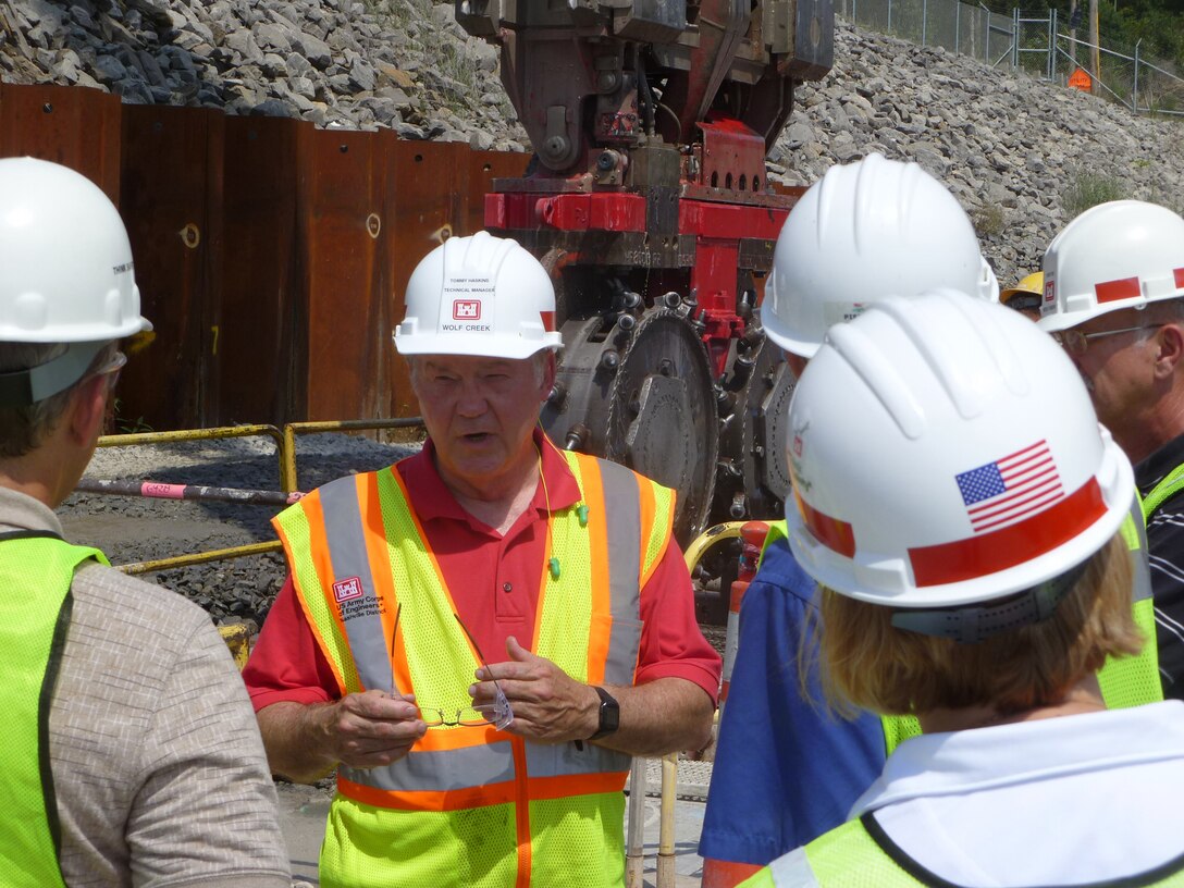 JAMESTOWN, Ky. —  Tommy Haskins, U.S. Army Corps of Engineers Nashville District technical manager for the Wolf Creek Dam Foundation Remediation Project in Jamestown, Ky., briefs the 2011 Post-Flood Performance Assessment team from USACE Headquarters during a tour of the project's work platform July 25, 2012. The higher headquarters team visited the dam as it seeks to identify potential revisions to water control manuals, and recommend operational changes, both within and outside of existing authorities and policies.