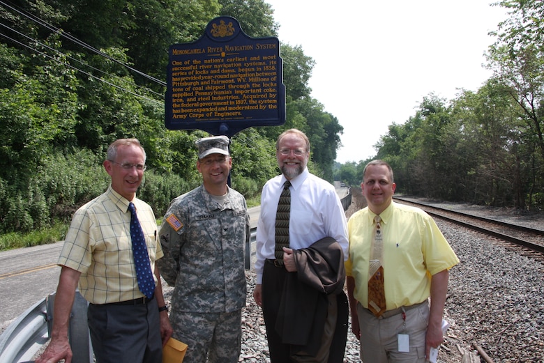 ELIZABETH, Pa. — Conrad Weiser, Environmental and Cultural Resources, Col. William Graham, U.S. Army Corps of Engineers Pittsburgh District Commander, Andrew Masich, Pennsylvania Historical and Museum Commission Chairman, and Brush Kish stand beneath the historical marker at the Elizabeth Locks. A historical marker recognizing the Monongahela River Navigation System as one of the nation's most historically successful river systems was dedicated June 18 at Locks and Dam 3, Monongahela River.